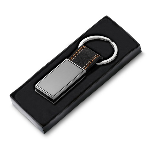 Chaveiro de metal em níquel brilhante + PU. 8,5x3cm